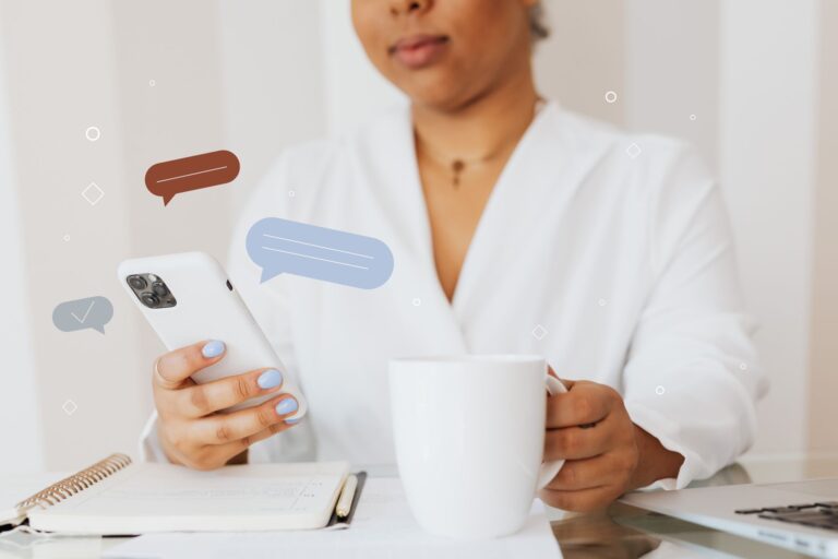 A teacher checks a phone to send a text message to a student's family before the school day begins